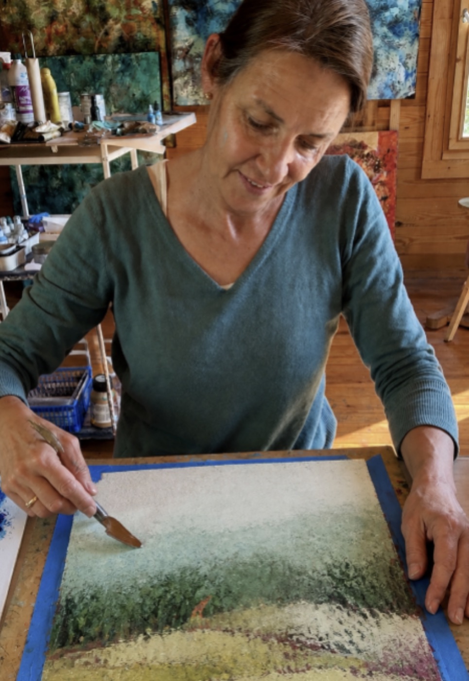 Marina painting a textured landscape in cold wax and oils