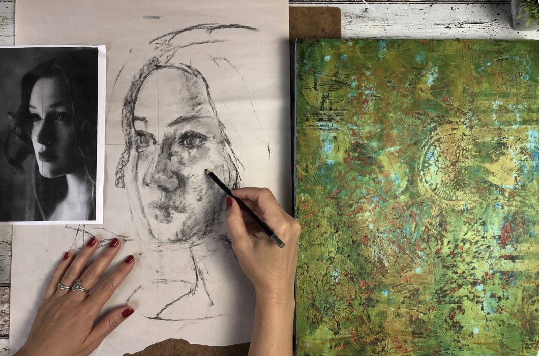 A reference photograph and portrait drawing beside the colourful textured background used in the class